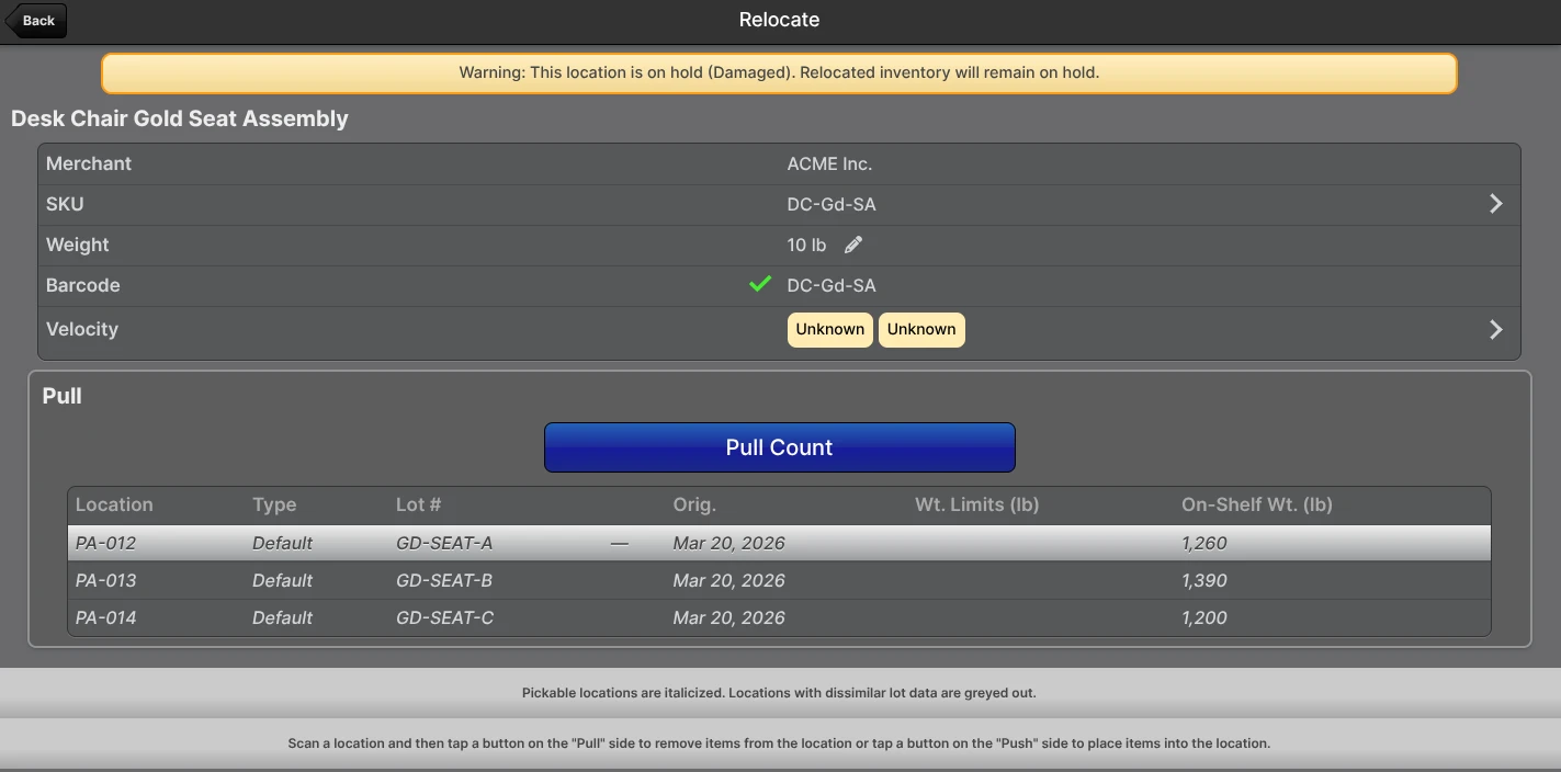 Scanner Relocate page showing "Warning: This location is on hold (Damaged). Relocated inventory will remain on hold." when pulling from a held source whose Hold Reason allows relocation